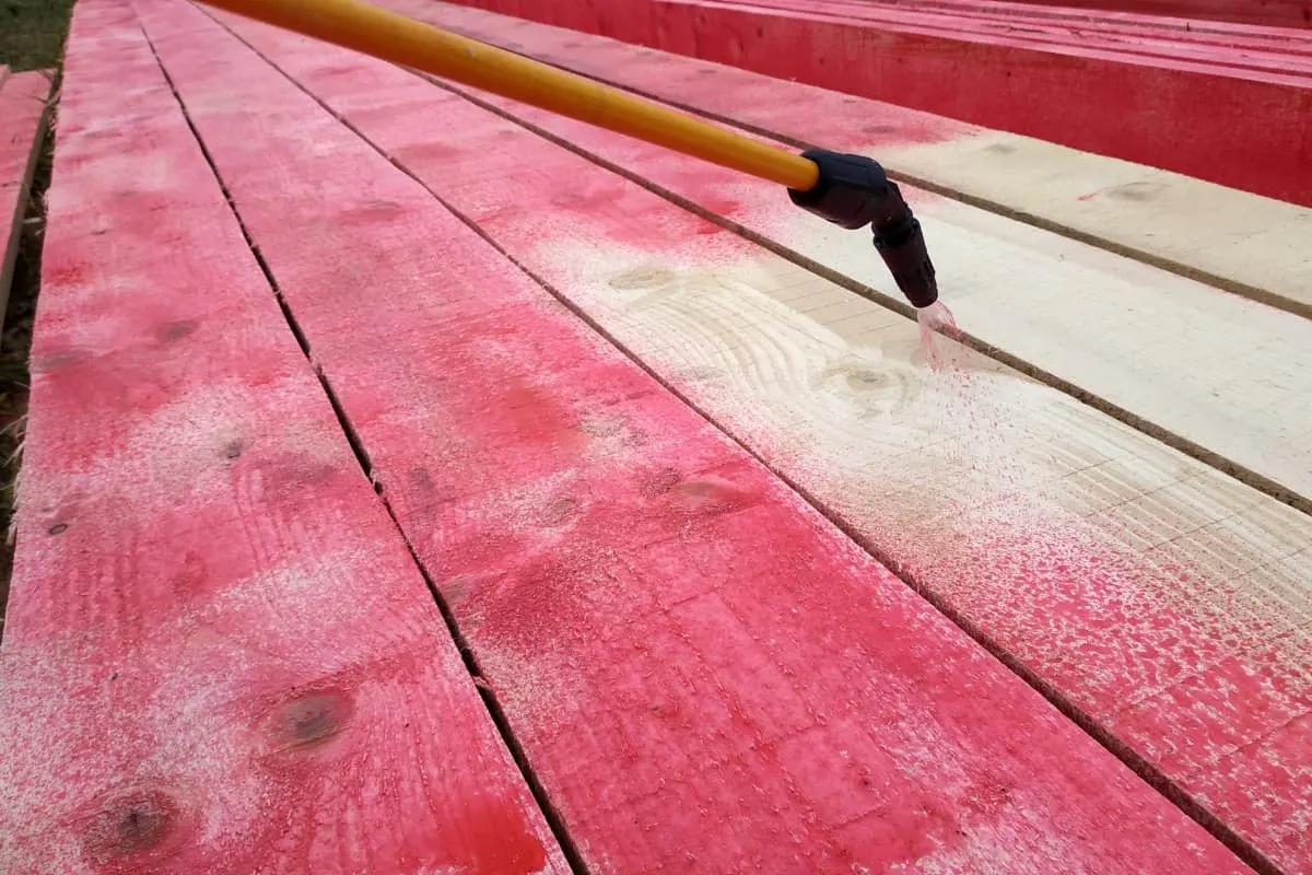 Rociando la terraza con pintura roja.